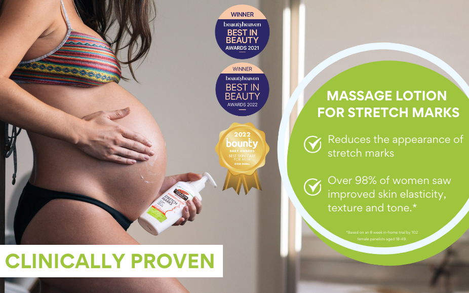 pregnant woman holding massage lotion for stretch marks